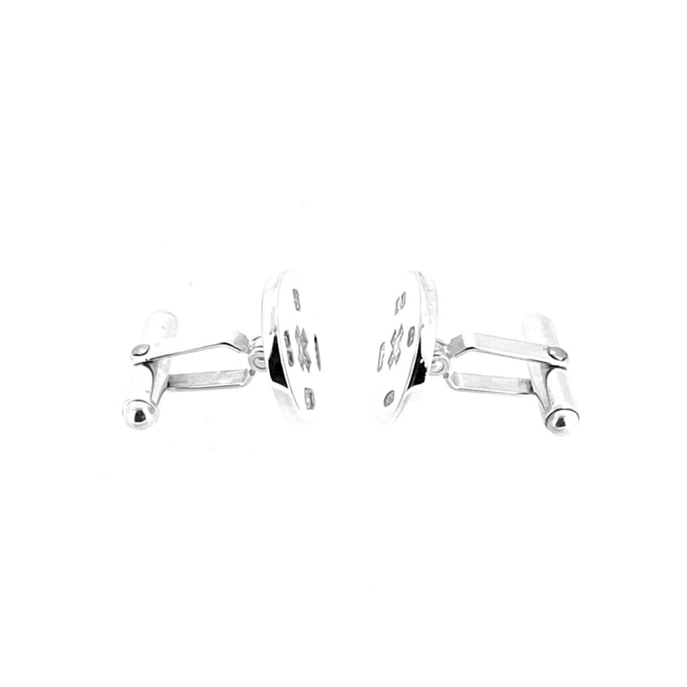 Close view of millennium cufflinks with AJ maker’s mark and 925 silver mark