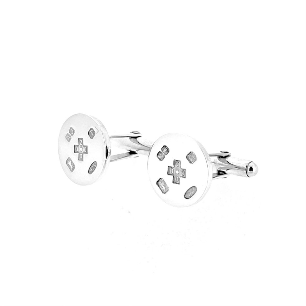 Round silver cufflinks with visible feature hallmarks across the front