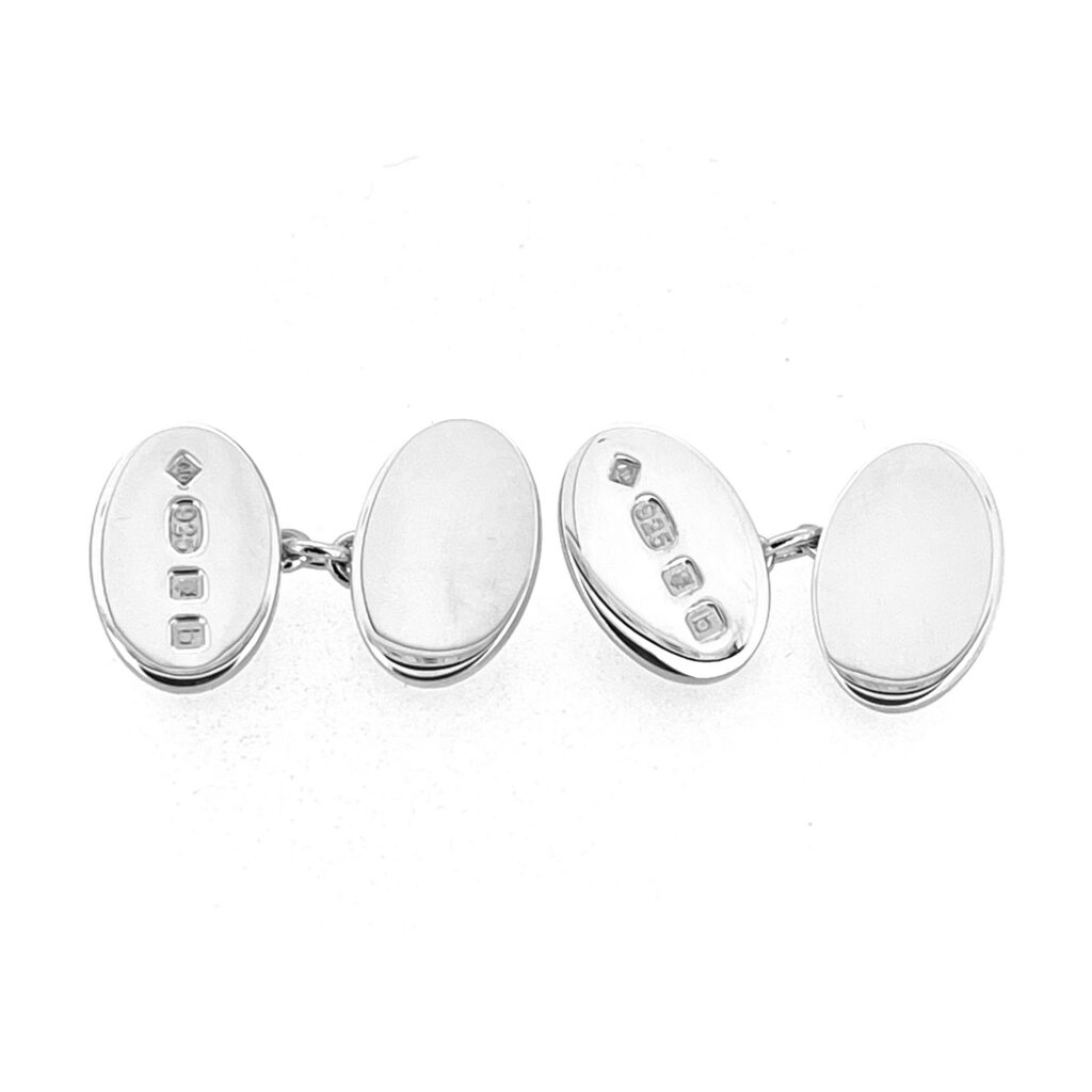 Pair of vintage oval Dunhill cufflinks with one plain polished face and one hallmarked face