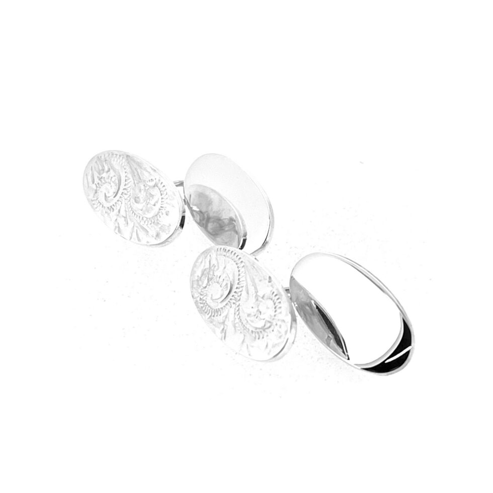 Vintage sterling silver oval cufflinks with polished plain backs and engraved Celtic Revival style fronts