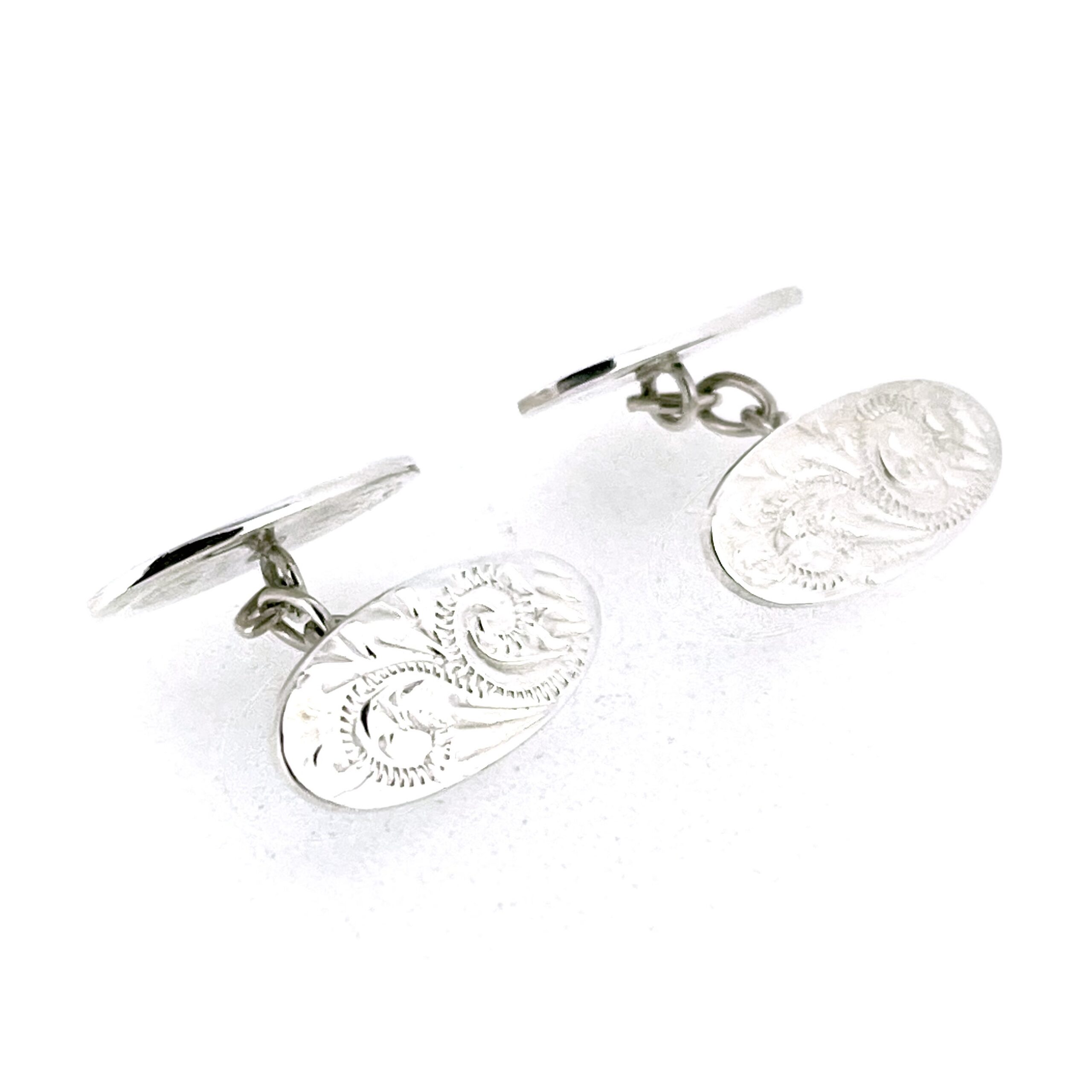 Vintage oval sterling silver cufflinks with polished plain side and patterned engraved side
