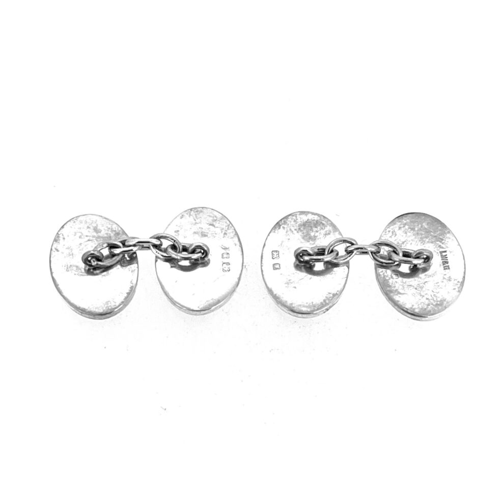 Close view of engraved vintage silver cufflinks with refined mid-century design