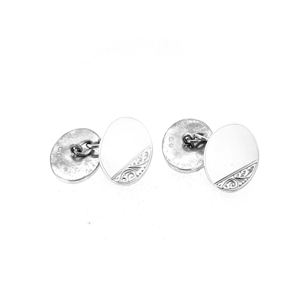 Pair of vintage silver cufflinks with engraved scroll border and polished plain oval field